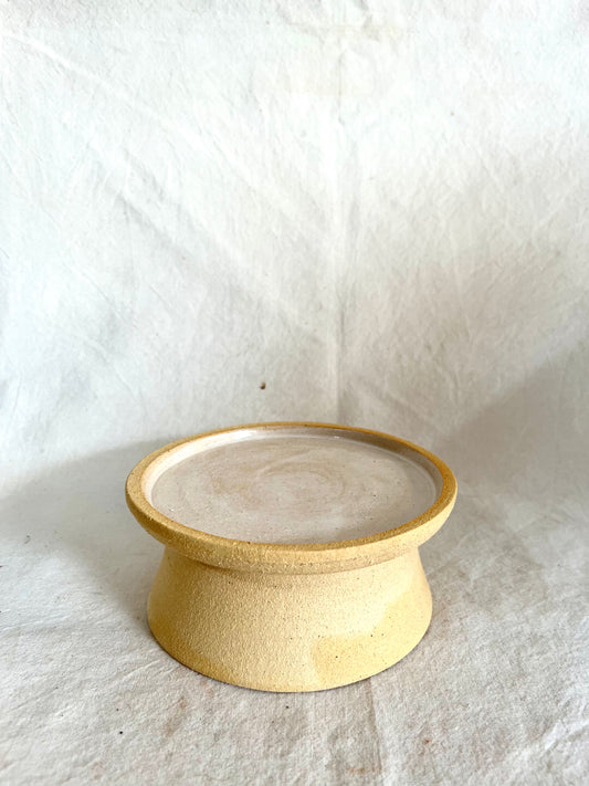 62 Buff pedestal saucer